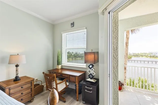 a view of a workspace with furniture and a window
