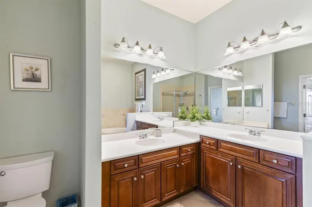 a spacious bathroom with a double vanity sink mirror and toilet