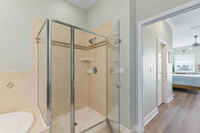 a bedroom with a large bed and a chandelier