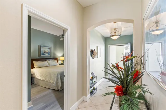 a bedroom with a bed and a chandelier