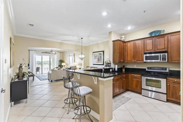 a kitchen with stainless steel appliances granite countertop a stove top oven a sink dishwasher and cabinets