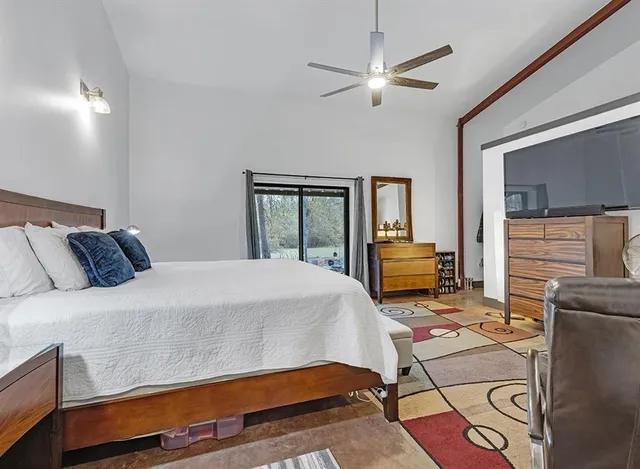 a bedroom with a bed and window