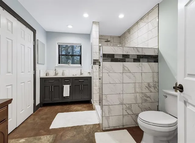 a bathroom with a sink a toilet and a mirror