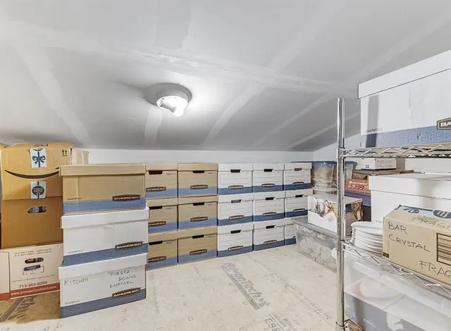 a view of walk in closet with clothes