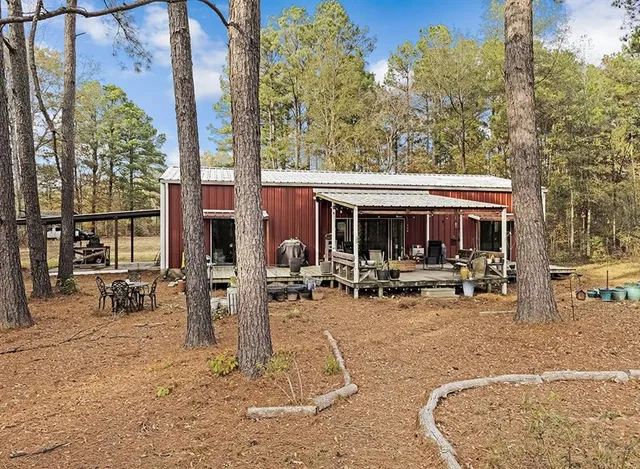 a view of a house with backyard porch and sitting area