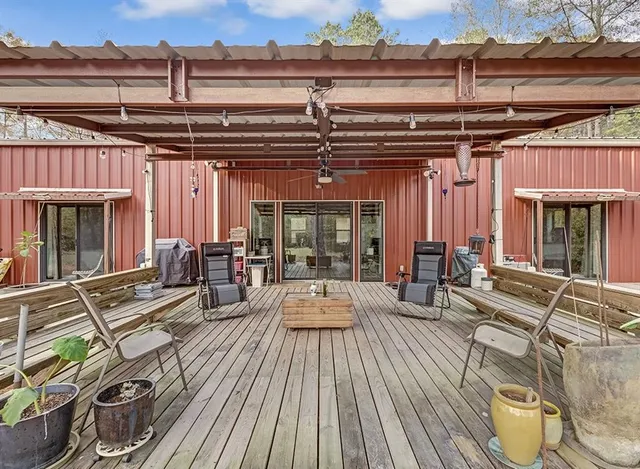 a view of a patio with table and chairs and wooden floor