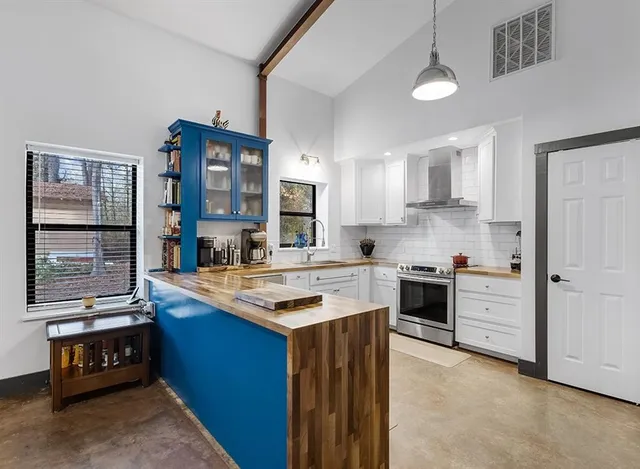 a kitchen with stainless steel appliances granite countertop a stove and a sink