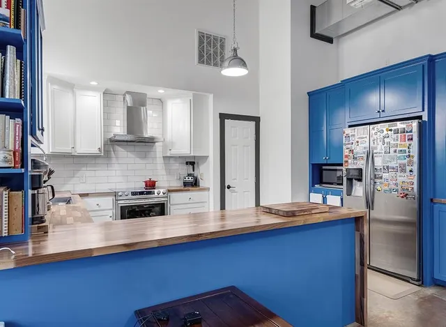 a kitchen with stainless steel appliances a sink a stove and refrigerator