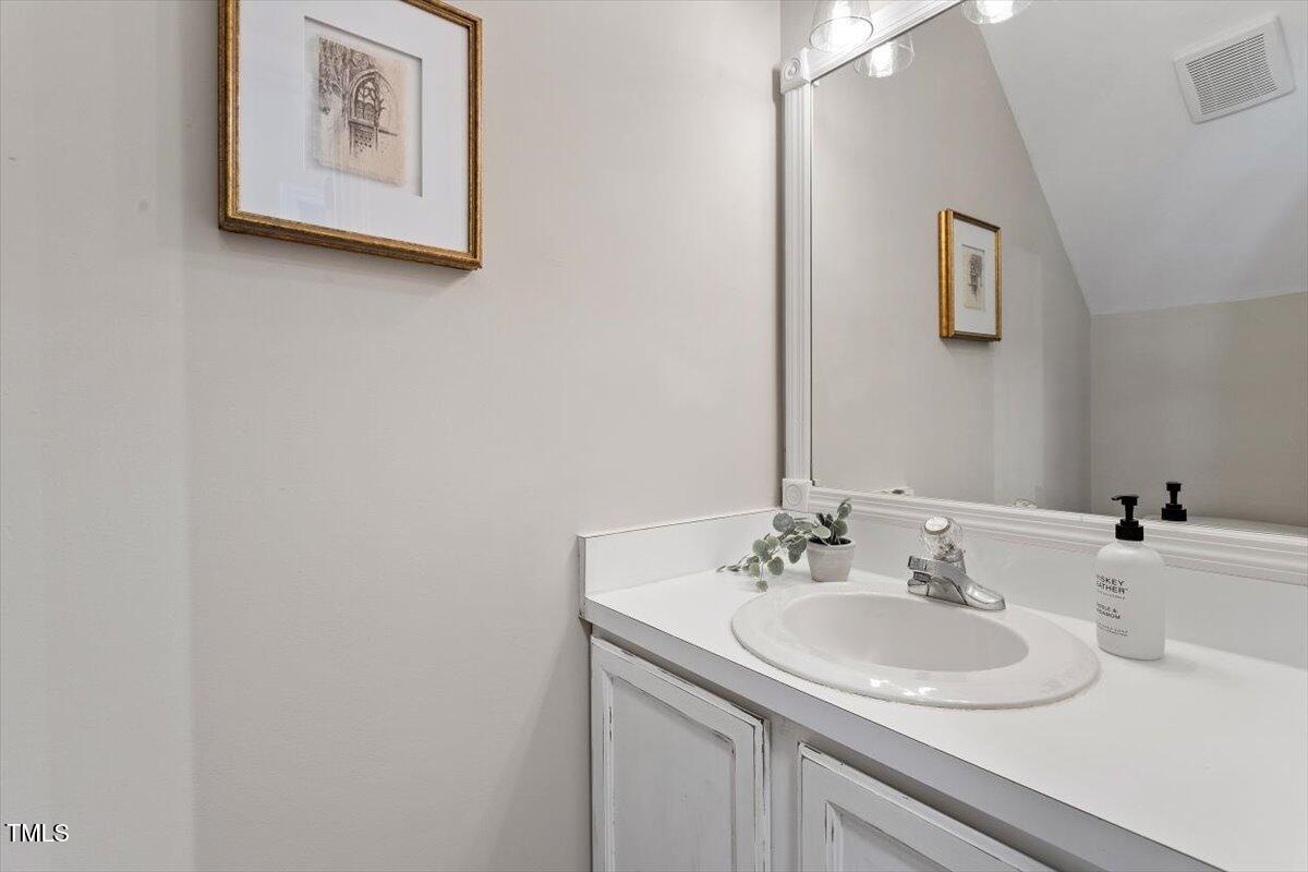 4714 Lazyriver Drive Durham, NC 27712 - Photo 13 of 37 a bathroom with a sink and a mirror