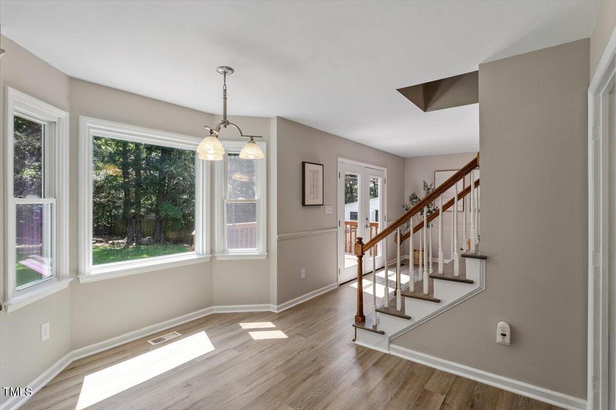 4714 Lazyriver Drive Durham, NC 27712 - Photo 16 of 37 a view of an entryway with wooden floor and windows