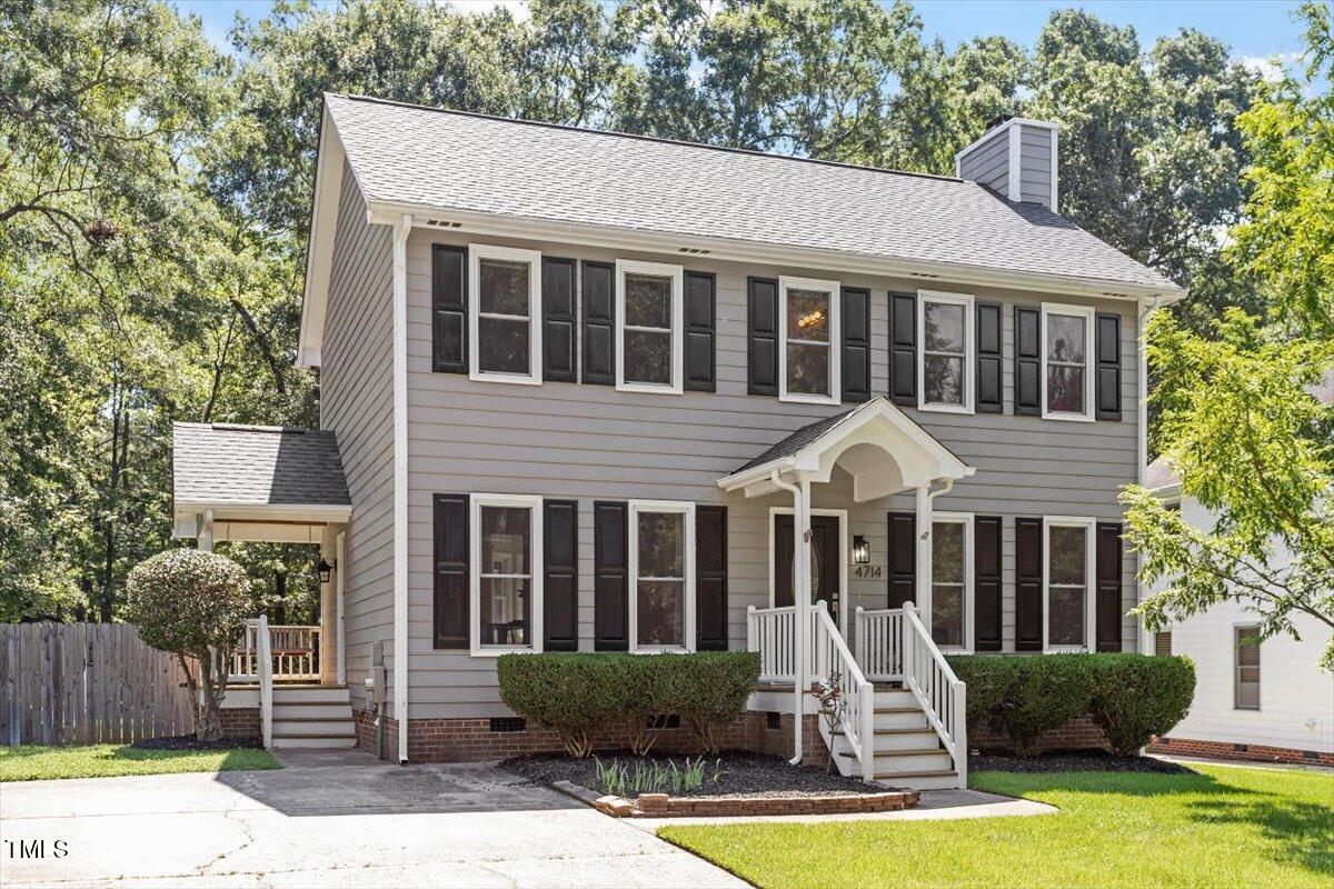 4714 Lazyriver Drive Durham, NC 27712 - Photo 2 of 37 a front view of a house with porch yard and glass windows