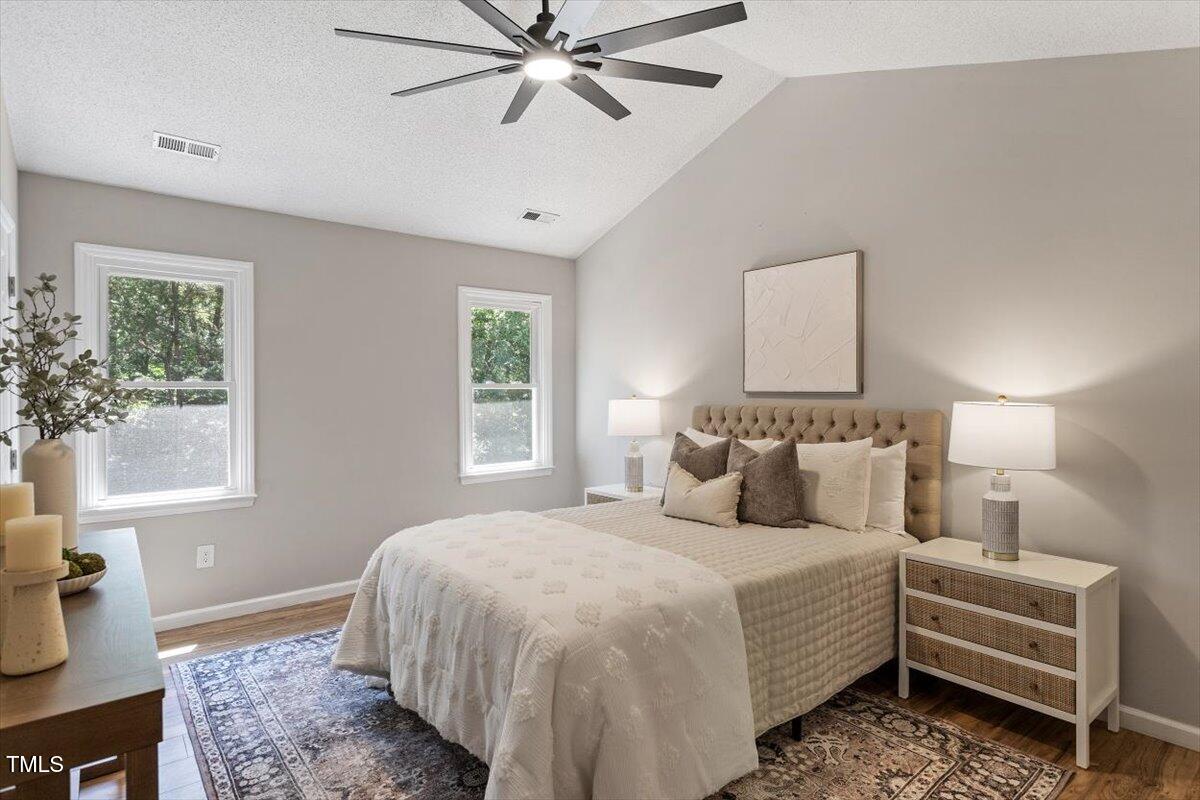4714 Lazyriver Drive Durham, NC 27712 - Photo 23 of 37 a bedroom with a large bed and a window
