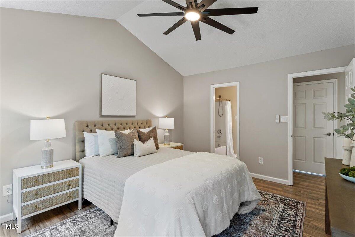 4714 Lazyriver Drive Durham, NC 27712 - Photo 24 of 37 a bedroom with a bed and a chandelier