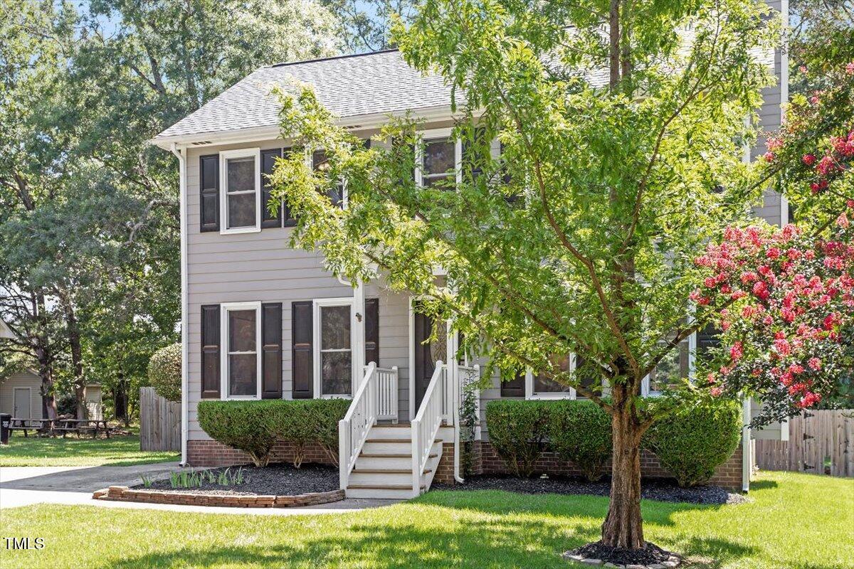 4714 Lazyriver Drive Durham, NC 27712 - Photo 35 of 37 a front view of a house with garden and trees