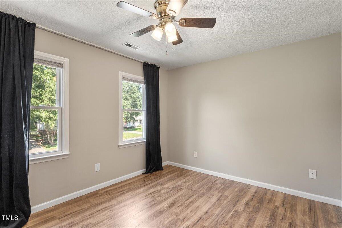 4714 Lazyriver Drive Durham, NC 27712 - Photo 36 of 37 a view of an empty room with window and wooden floor