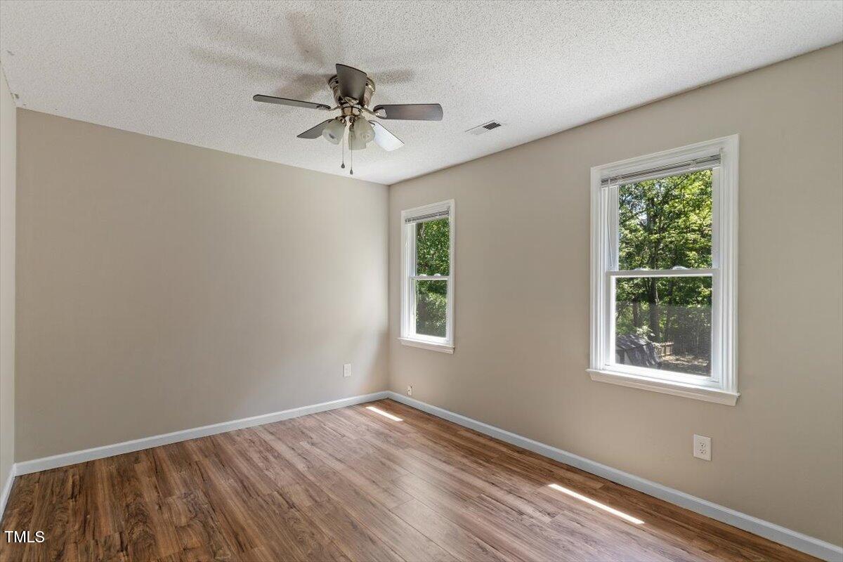 4714 Lazyriver Drive Durham, NC 27712 - Photo 37 of 37 a view of an empty room with wooden floor and a window