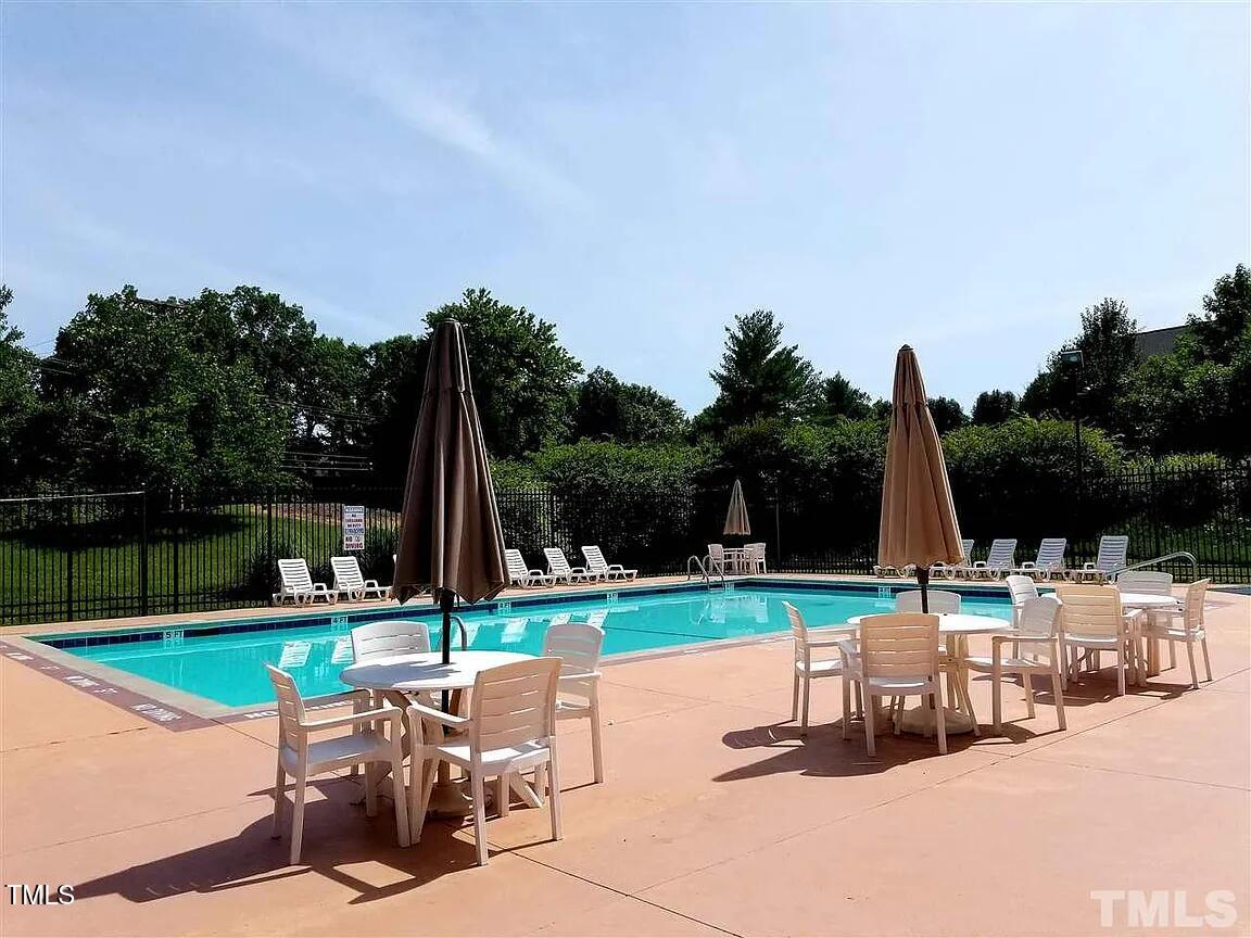 4714 Lazyriver Drive Durham, NC 27712 - Photo 5 of 37 a view of a two chairs and table in the back yard