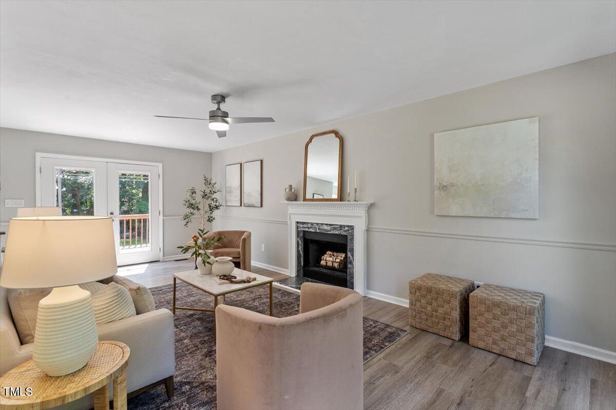 4714 Lazyriver Drive Durham, NC 27712 - Photo 9 of 37 a living room with furniture a fireplace and a large window