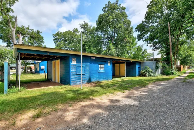 a view of a house with a yard and tree