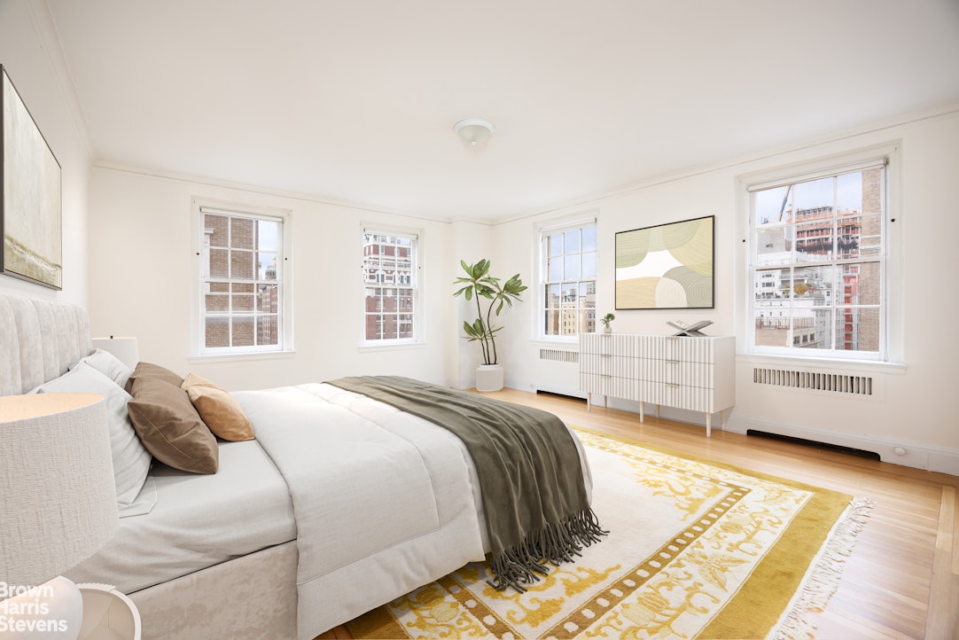 1001 Park Avenue, Unit 11 Manhattan, NY 10028 - Photo 10 of 17 a bedroom with a large bed and a window