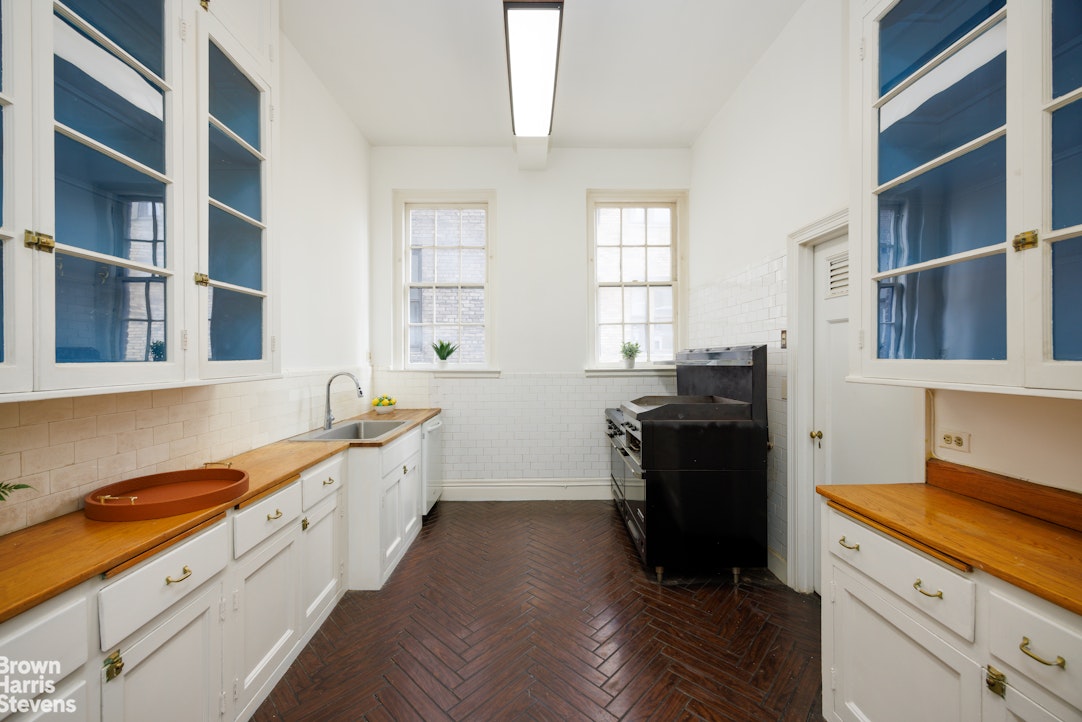 1001 Park Avenue, Unit 11 Manhattan, NY 10028 - Photo 15 of 17 a kitchen with a sink and a stove top oven