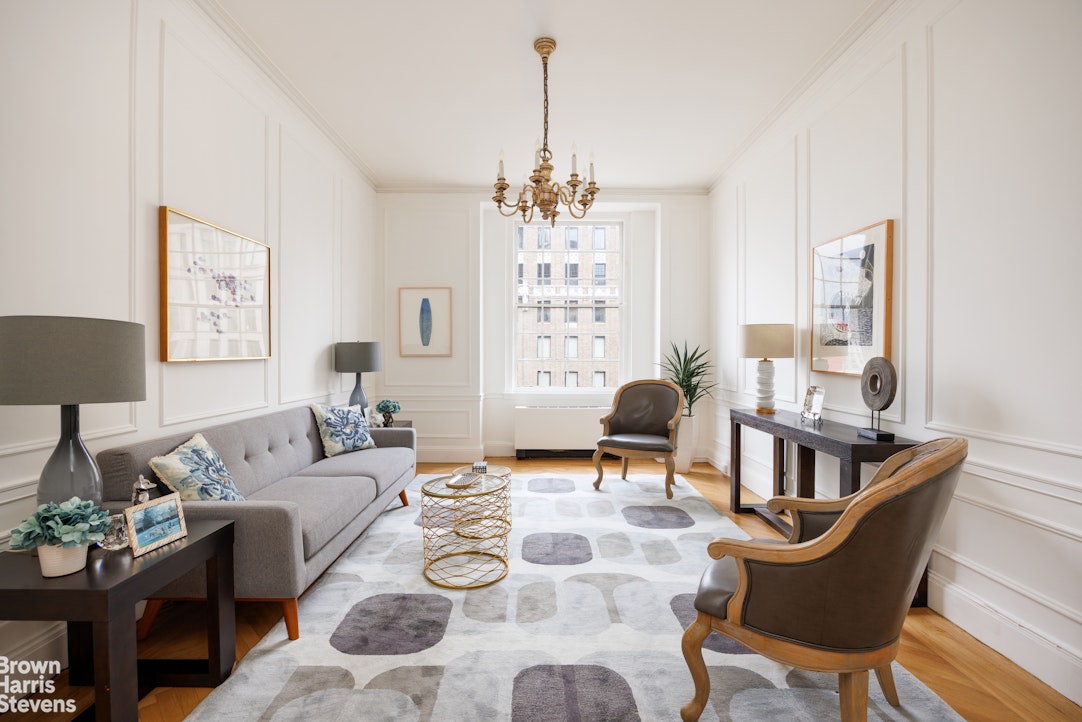 1001 Park Avenue, Unit 11 Manhattan, NY 10028 - Photo 8 of 17 a living room with furniture and a chandelier