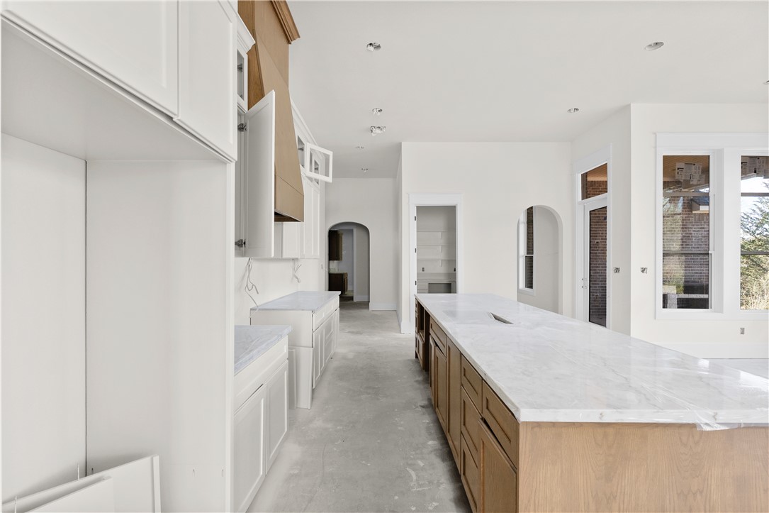3026 Silverbell Court Bryan, TX 77807 - Photo 15 of 30 a large white kitchen with sink and stainless steel appliances
