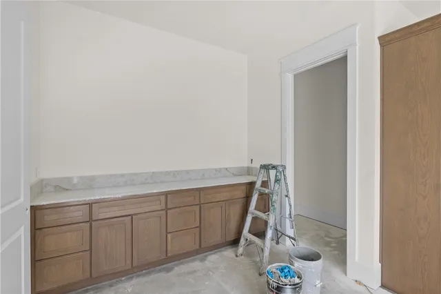a view of storage and utility room with cabinet dryer and washer