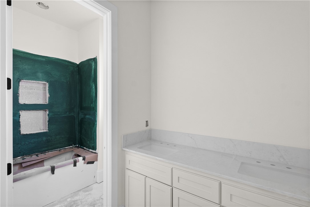 3026 Silverbell Court Bryan, TX 77807 - Photo 27 of 30 a bathroom with a bathtub and a sink