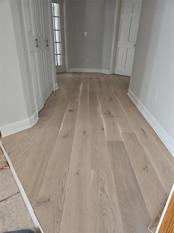 137 Oakview Gainesville, TX 76240 - Photo 13 of 39 Hallway To Bedrooms Showing White Hardwood