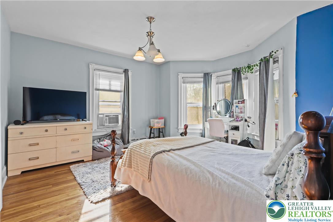 225 South Walnut Street Bath, PA 18014 - Photo 13 of 20 a bedroom with a bed and a chandelier