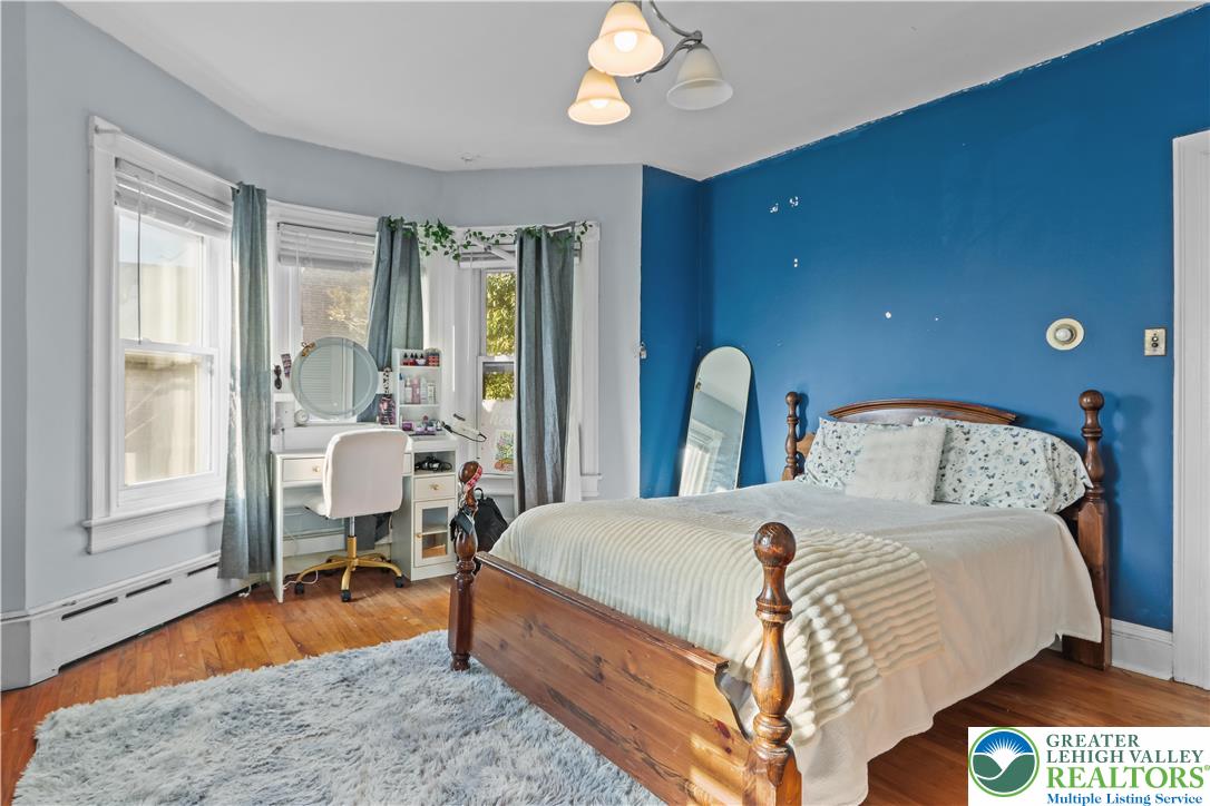 225 South Walnut Street Bath, PA 18014 - Photo 14 of 20 a bedroom with a bed and a chandelier