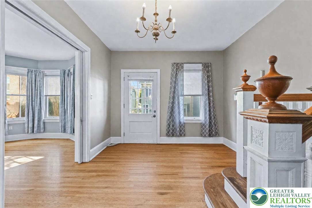 225 South Walnut Street Bath, PA 18014 - Photo 4 of 20 a view of a livingroom with wooden floor and a chandelier