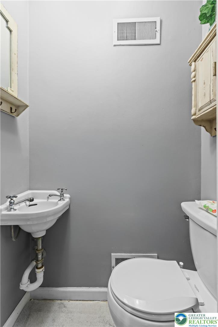 225 South Walnut Street Bath, PA 18014 - Photo 5 of 20 a bathroom with a sink a toilet and a mirror