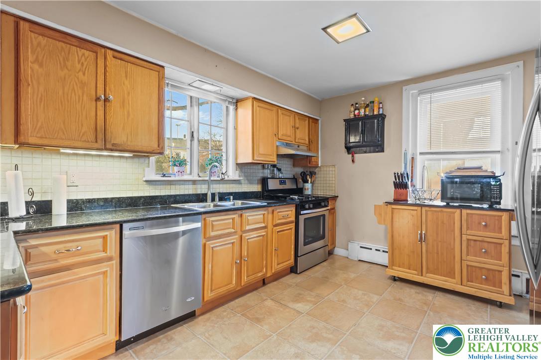 225 South Walnut Street Bath, PA 18014 - Photo 6 of 20 a kitchen with stainless steel appliances granite countertop a stove a sink and a refrigerator