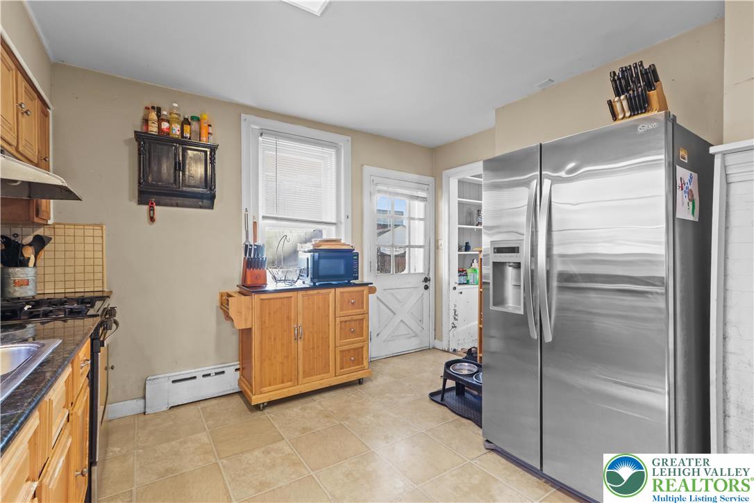 225 South Walnut Street Bath, PA 18014 - Photo 7 of 20 a kitchen with stainless steel appliances a refrigerator and a stove top oven