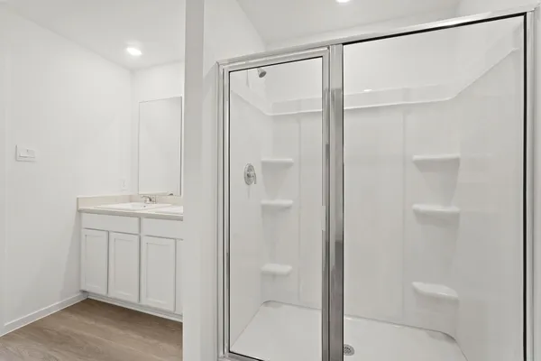 a bathroom with a shower and a sink