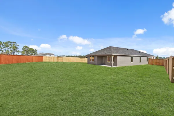 a view of yard with swimming pool and green space