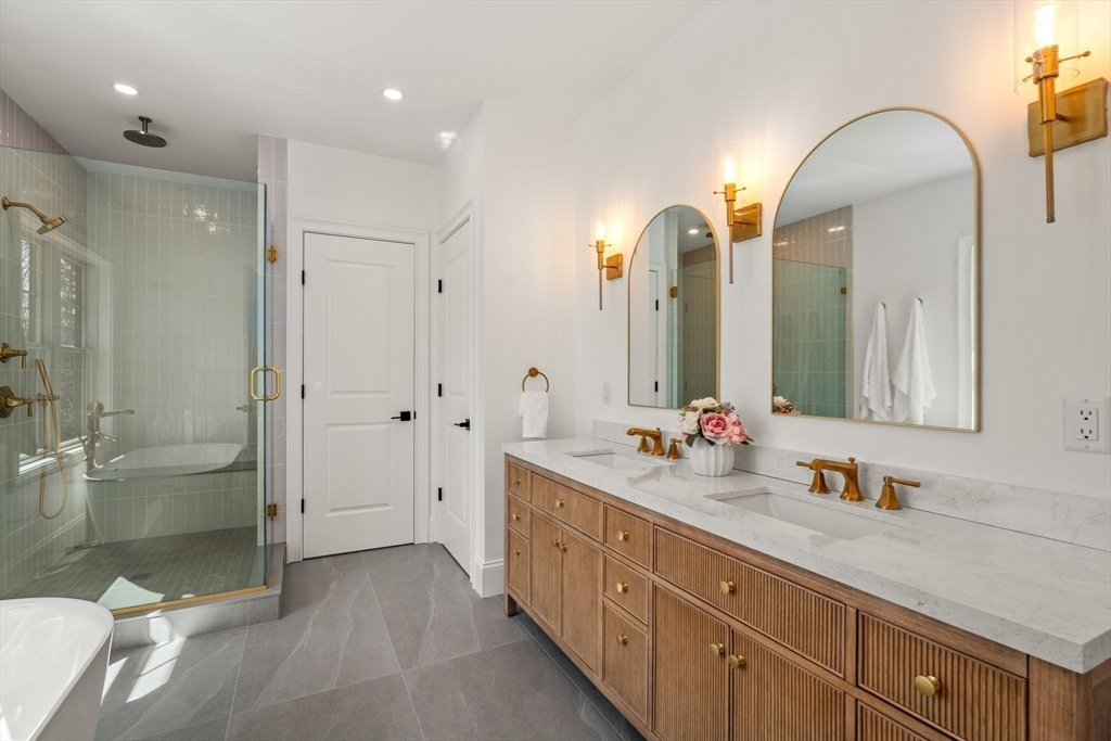 12 Sylvester Road Newton, MA 02465 - Photo 11 of 17 a spacious bathroom with double vanity sinks a toilet a shower and a mirror