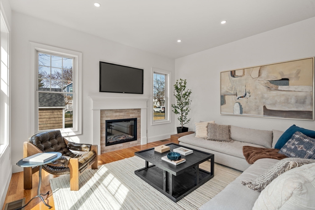 12 Sylvester Road Newton, MA 02465 - Photo 5 of 17 a living room with furniture a fireplace and a flat screen tv
