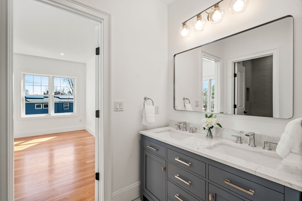 12 Sylvester Road Newton, MA 02465 - Photo 9 of 17 a bathroom with a sink double vanity and a mirror