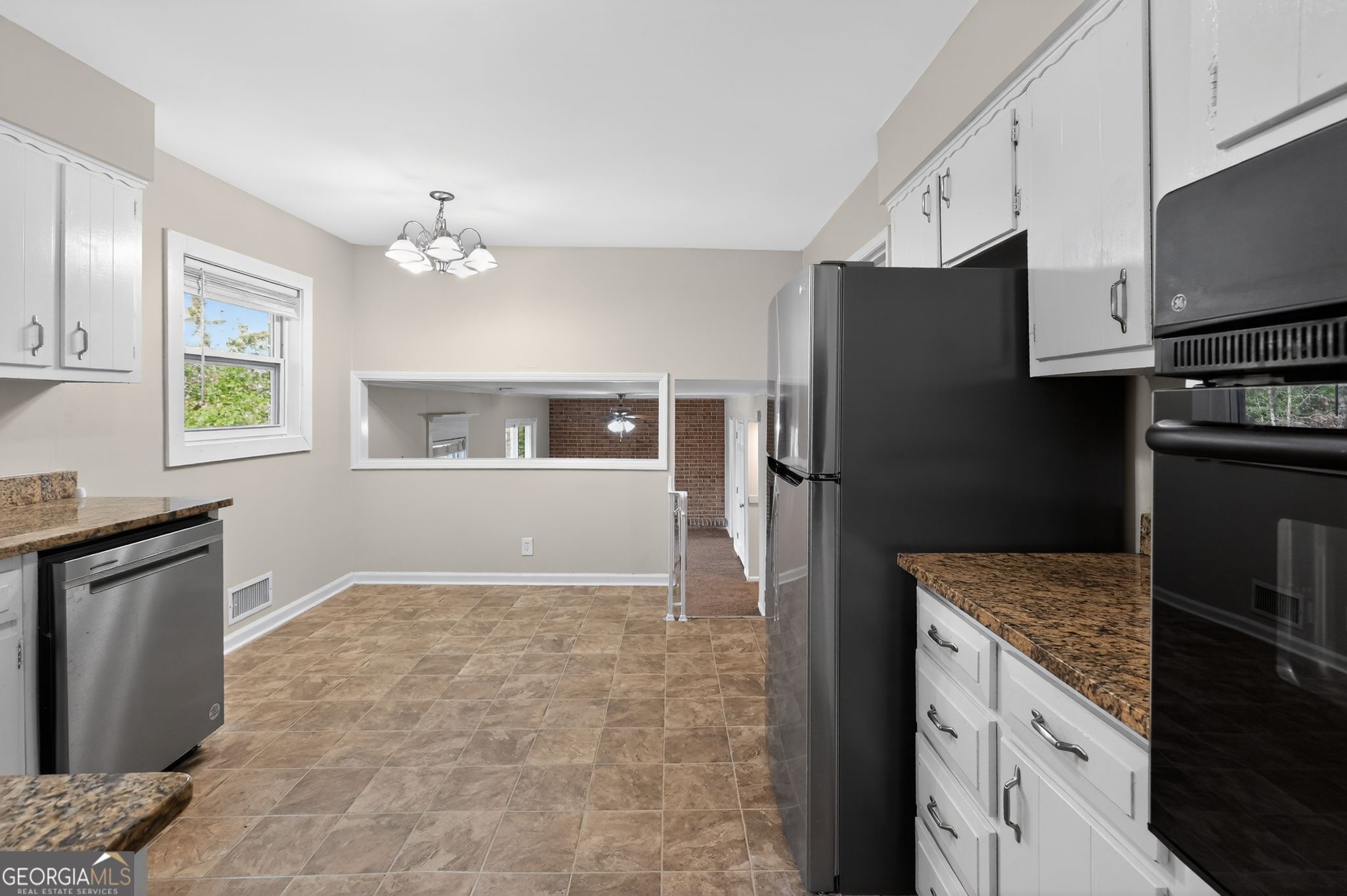 2897 Leisure Woods Lane Decatur, GA 30034 - Photo 16 of 32 a kitchen with granite countertop a refrigerator and a stove top oven