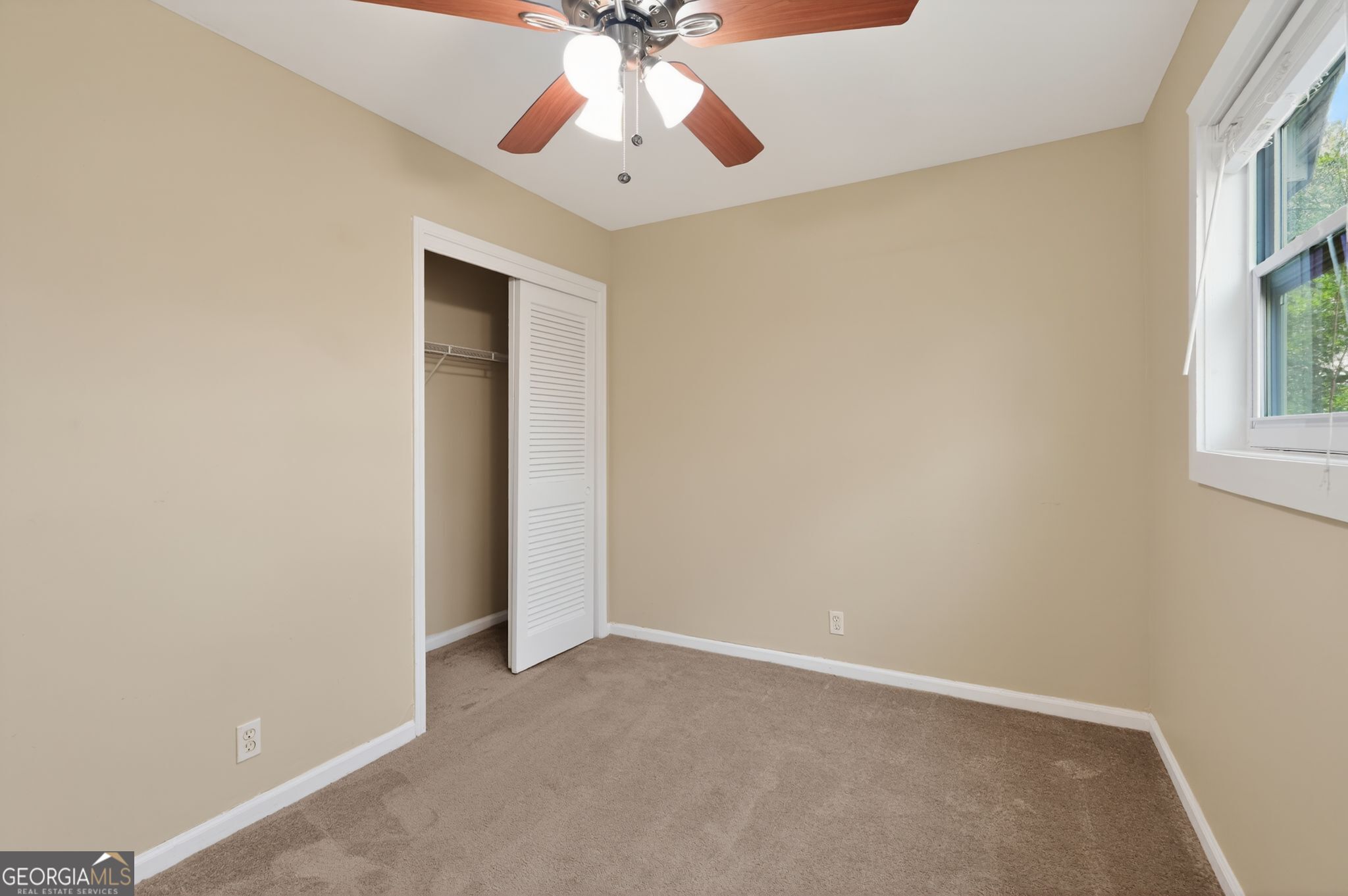 2897 Leisure Woods Lane Decatur, GA 30034 - Photo 18 of 32 an empty room with a window and a fan
