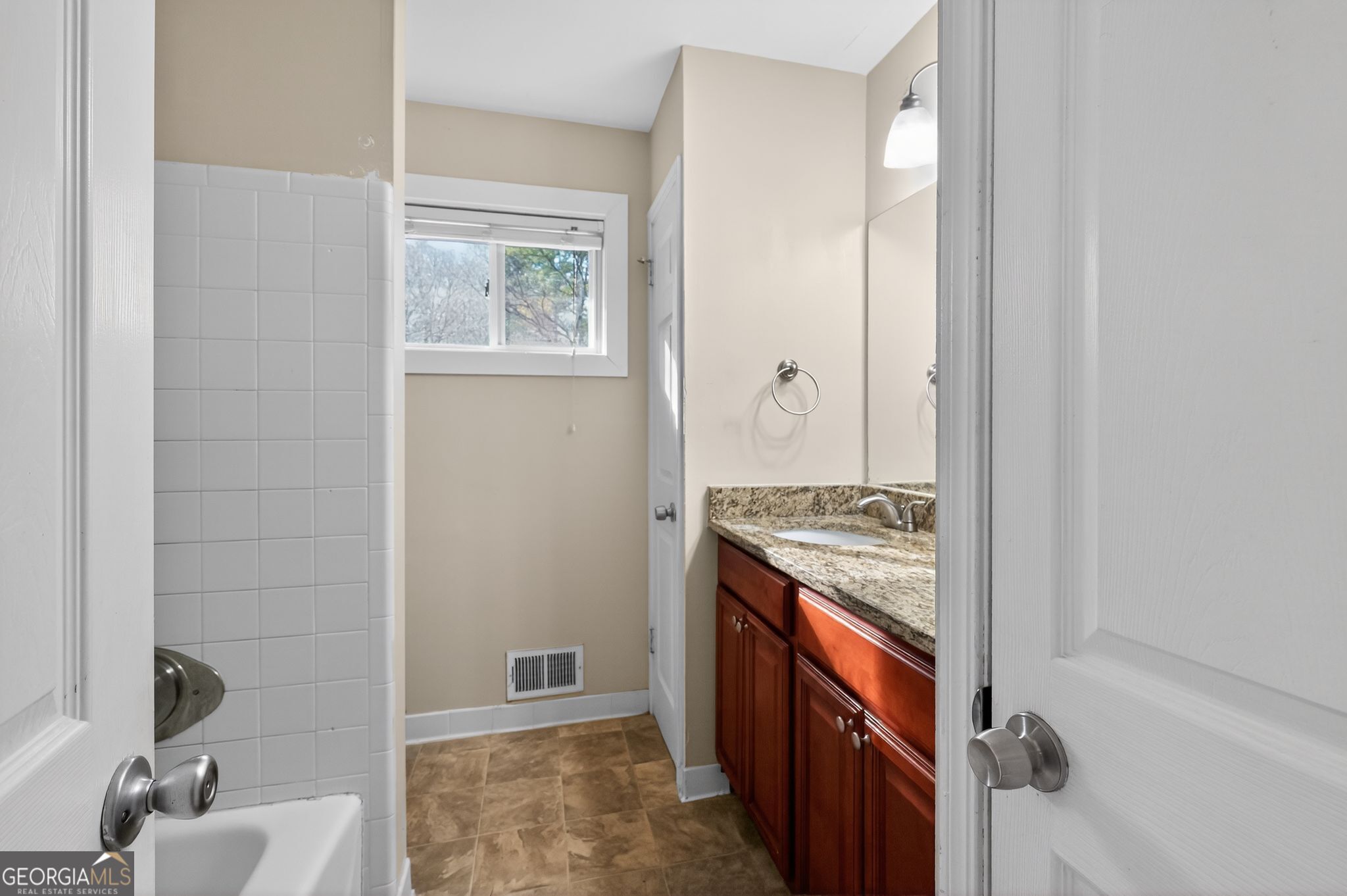 2897 Leisure Woods Lane Decatur, GA 30034 - Photo 22 of 32 a bathroom with a granite countertop sink a mirror and a