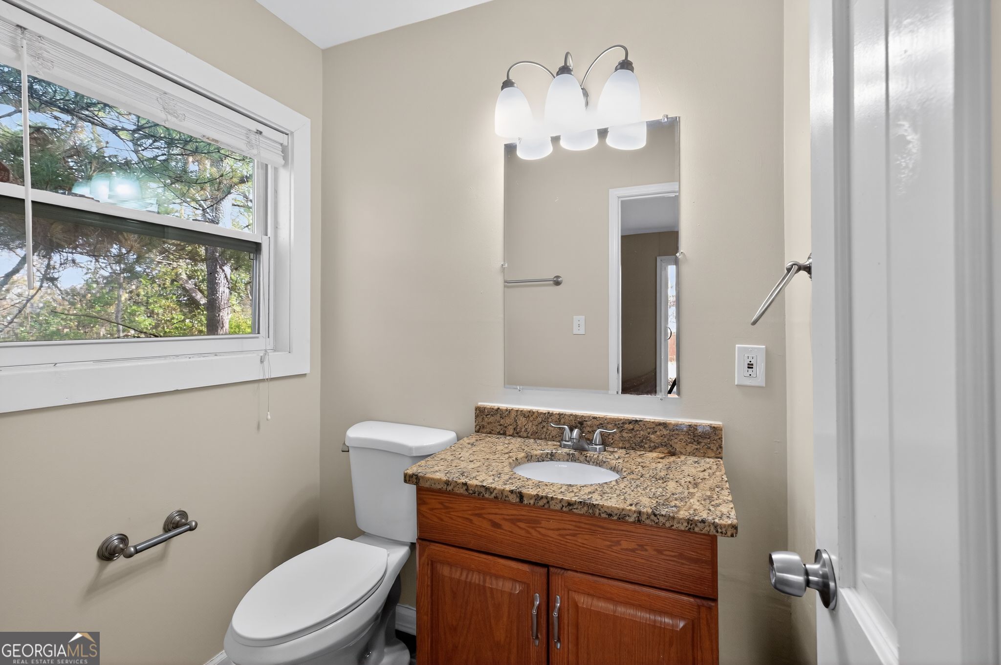 2897 Leisure Woods Lane Decatur, GA 30034 - Photo 23 of 32 a bathroom with a granite countertop sink toilet and mirror