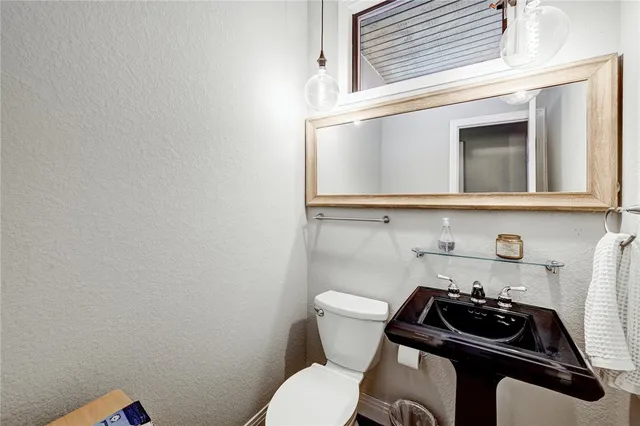 a bathroom with a sink a toilet and vanity