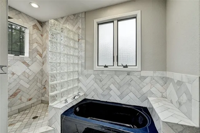 a bathroom with a sink a mirror and a shower