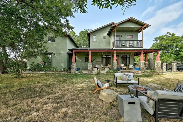 a view of a house with backyard porch and sitting area