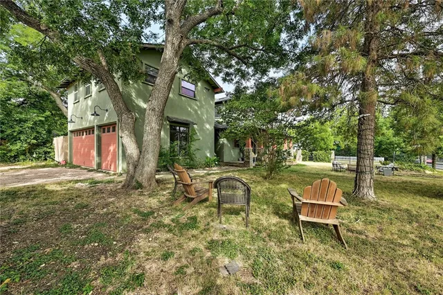 a view of a house with backyard and sitting area