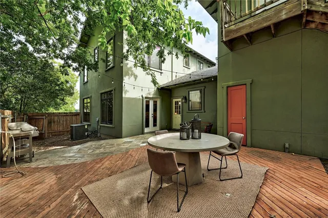 a view of a patio with table and chairs and potted plants